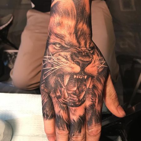 Leo inked on the dorsal part of the hand.